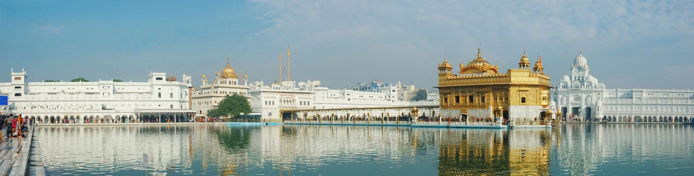 AMRITSAR, INDIA - DECEMBER 12: worshippers visiting sacred Golden Temple (Harmandir Sahib)  and making ritual bathing at holy lake on December 12,2012 in Amritsar,Punjab, India