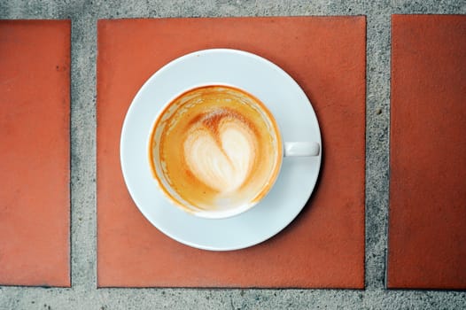 Empty Glass of Coffee on brown floor