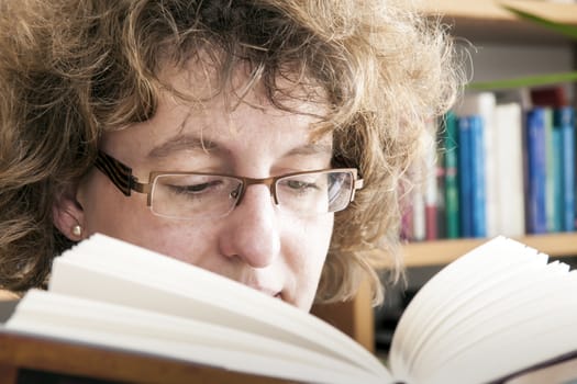 Young beautiful woman reading a book