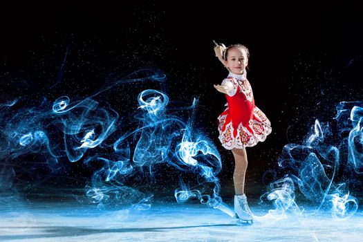 Little girl figure skating at sports arena