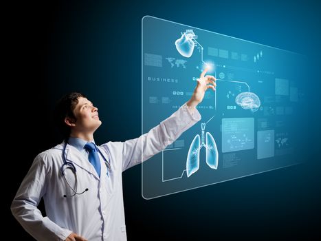 Young male doctor touching icon on media screen