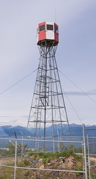 Forest fire watch tower tall architectural steel lookout structure overlooking mountain area of Tagish  Yukon Territory  Canada