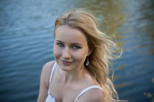 Beautiful young woman on the background of the sea.