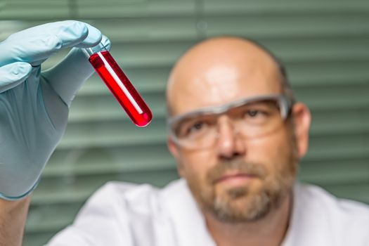 Scientific chemistry laboratory with red liquid in test tube