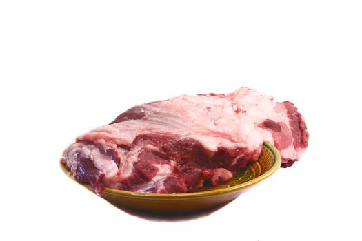 Fresh pork meat on ceramic dish. Presented on a white background.
