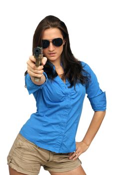 A lovely young brunette points a modern handgun at the camera.  Selective focus on the handgun.  Isolated on a white background with generous copyspace.