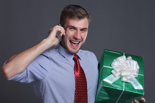 Portrait of young business man with gifts