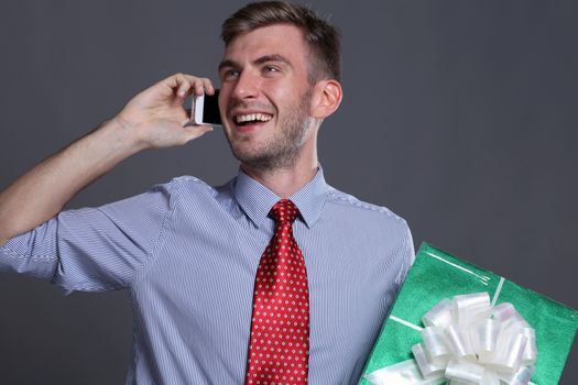 Portrait of young business man with gifts