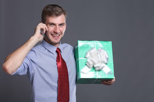 Portrait of young business man with gifts