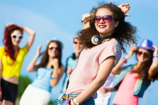 Image of young attractive woman with friends at background