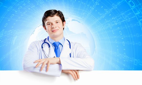 Image of handsome doctor holding white blank banner