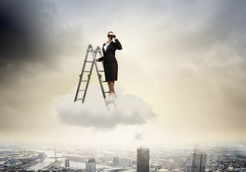 Image of businesswoman standing on ladder and looking in binoculars