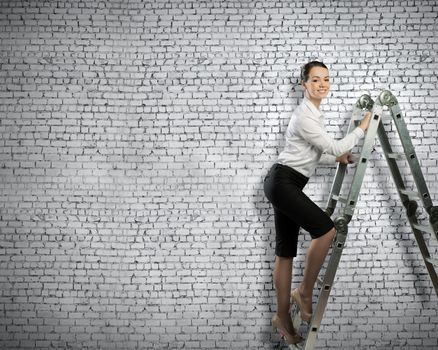 Image of young ambitious businesswoman climbing ladder. Promotion concept