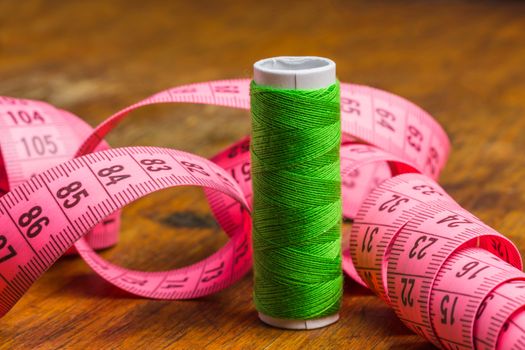 Sewing on the background of the old wooden walls