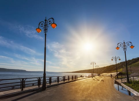 Street lights on the promenade on the shore of the great river