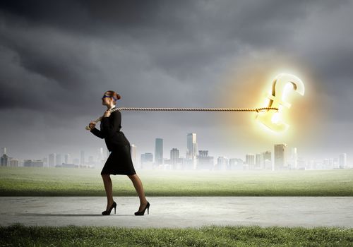 Image of businesswoman pulling pound sign with rope