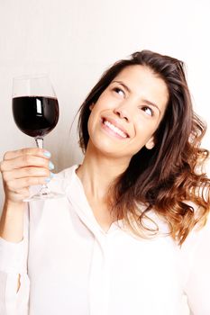 Portrait of a beautiful, latin Woman drinking red wine.