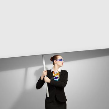 Image of businesswoman holding blank banner. Place for text