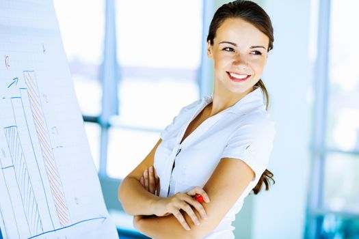 Image of young attractive businesswoman with arms crossed on chest