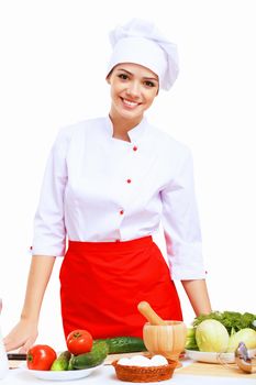 Young cook preparing food wearing a red apron