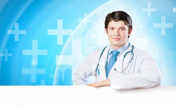 Young male doctor with blank banner. Place for text