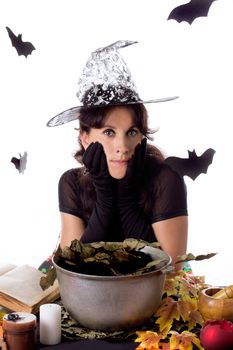 Witch making magic on Halloween isolated over white