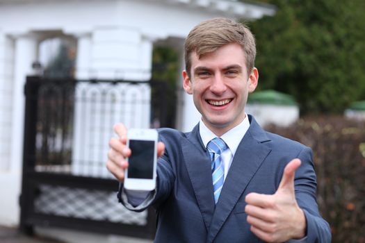 Portrait of young attractive man calling by phone