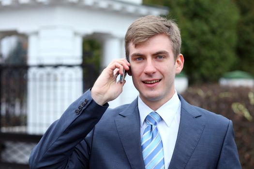 Portrait of young attractive man calling by phone