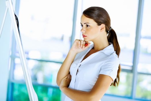 Image of young attractive businesswoman with arms crossed on chest