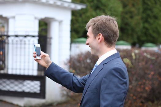 Portrait of young attractive man calling by phone