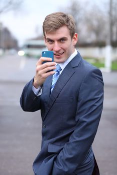 Portrait of young attractive man calling by phone