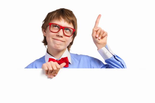 Image of young boy smiling thoughtfully holding white square. Place for advertisement