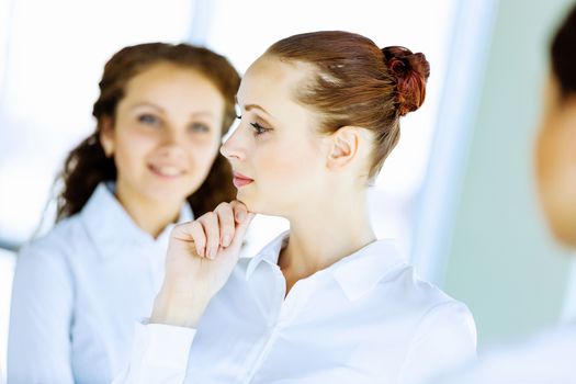 Image of three young businesswomen at meeting