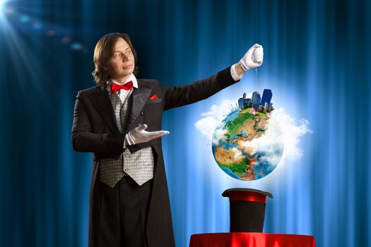 Image of wizard showing tricks with his hat. Ecology concept. Elements of this image are furnished by NASA