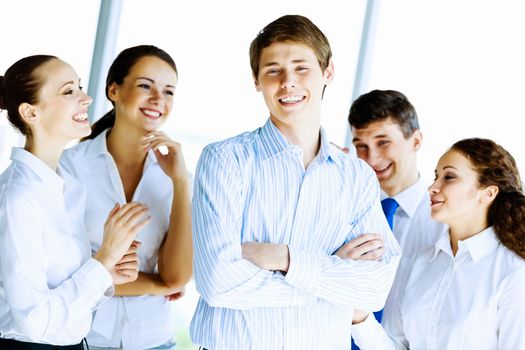 Image of young businesspeople congratulating colleague. Success concept