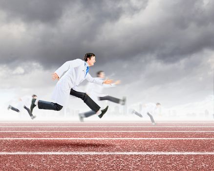 Funny image of young running doctor in white uniform