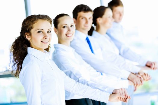 Image of young business people standing in line. Interaction concept