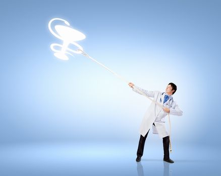 Image of male doctor pulling health sign with rope