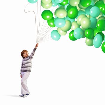 Image of little cute boy holding bunch of colorful balloons