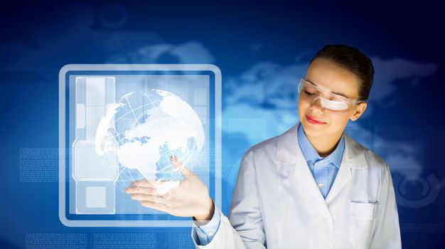 Image of young woman scientist in goggles against media screen