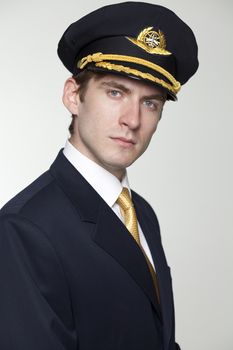 Portrait of a young man in the form of a passenger plane pilot