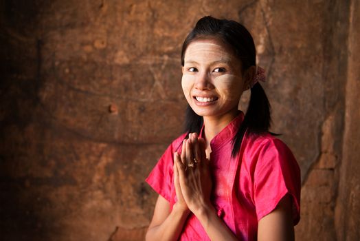 Myanmar girl in a traditional welcoming gesture