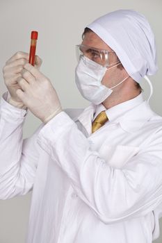 Doctor holding a beaker of blood