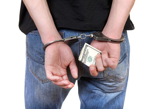 Handcuffs on the Hands with a Money Closeup Isolated on the White Background