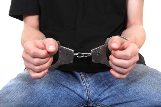 Front view of the Man in Handcuffs on the White Background Closeup