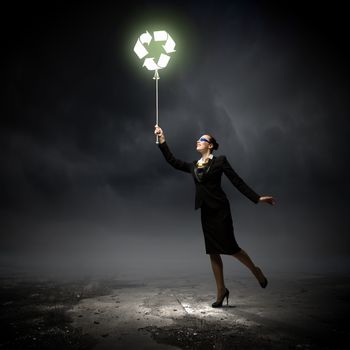 Image of businesswoman holding balloon with recycle symbol