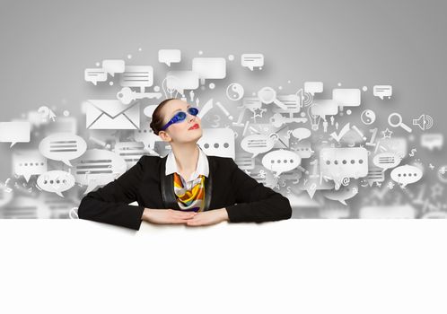 Image of young businesswoman wearing goggles and holding blank banner