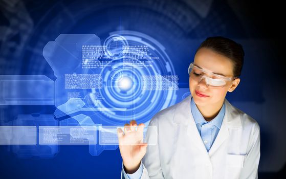 Image of young woman scientist in goggles against media screen