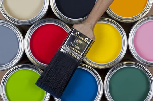 A selection of tins of colorful emulsion paint.