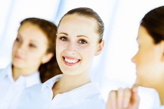 Image of three young businesswomen at meeting